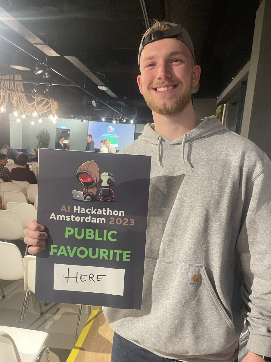Luuk holding the AI Hackathon Amsterdam 2023 Public Favourite poster