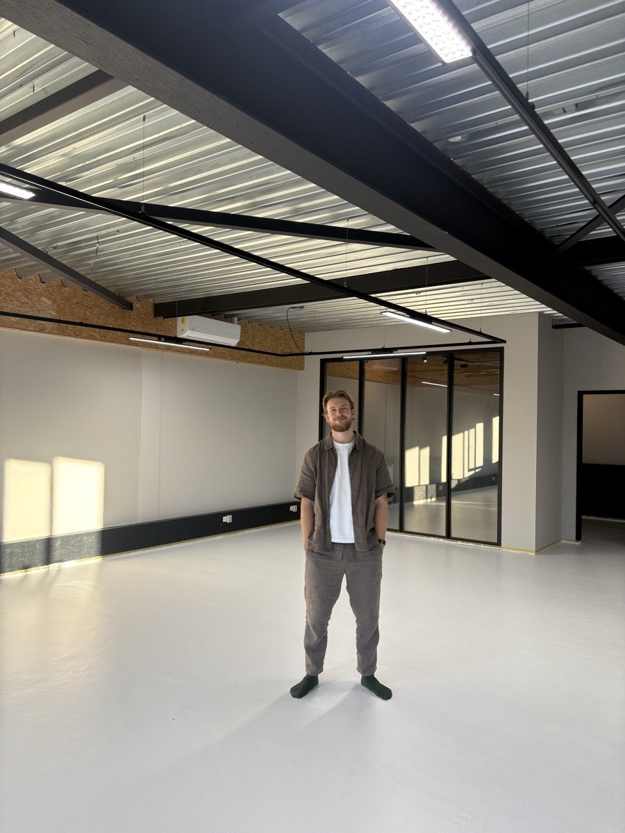 Luuk standing in a large empty studio space